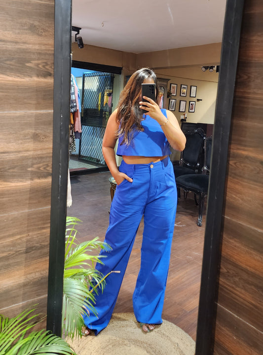Featuring a Solid Blue Crop Top with Wide Leg Trousers with pockets.