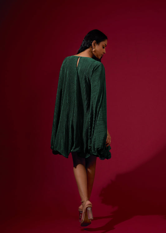 Woman wearing a green dress against a red background