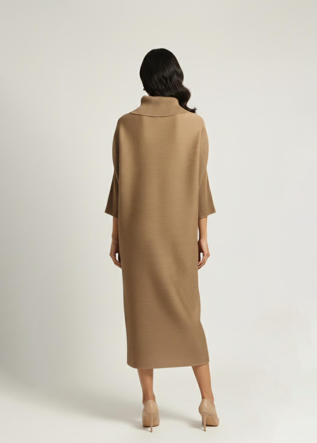 Woman wearing a beige dress against a white background