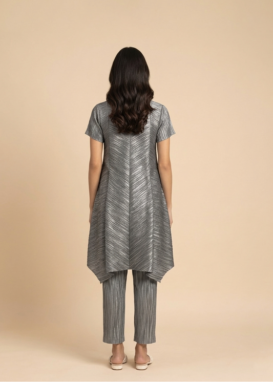 Woman wearing a gray striped outfit on a beige background