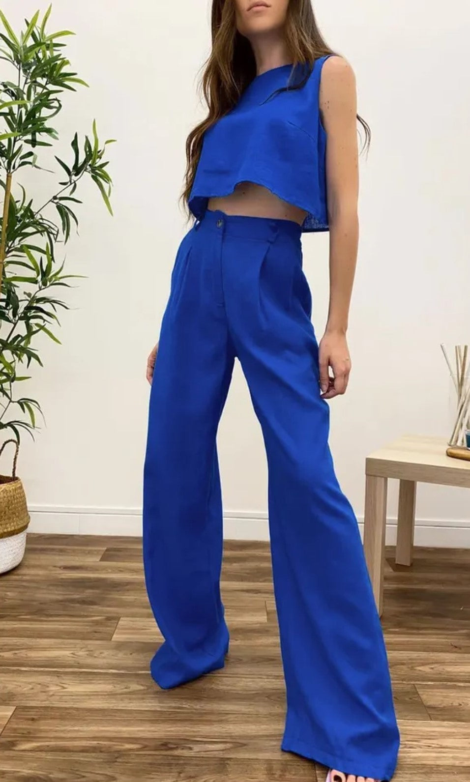 Featuring a Solid Blue Crop Top with Wide Leg Trousers with pockets.
