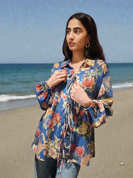 Woman wearing a floral kimono on a beach