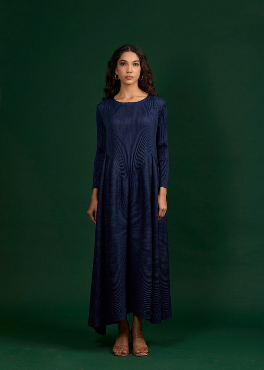 Woman wearing a navy blue dress against a green background