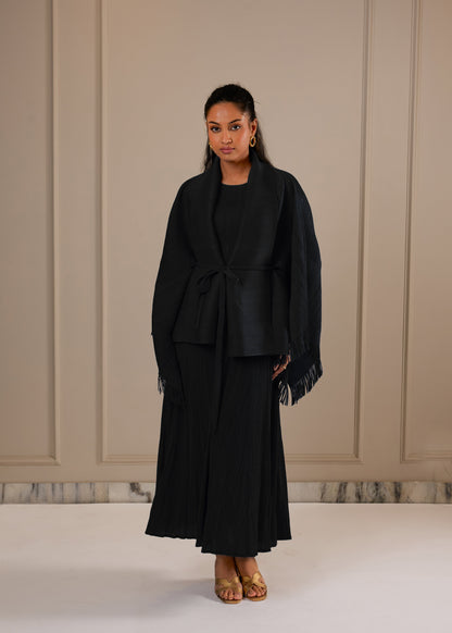 Woman wearing Black A line dress with Fringe cape and a belt