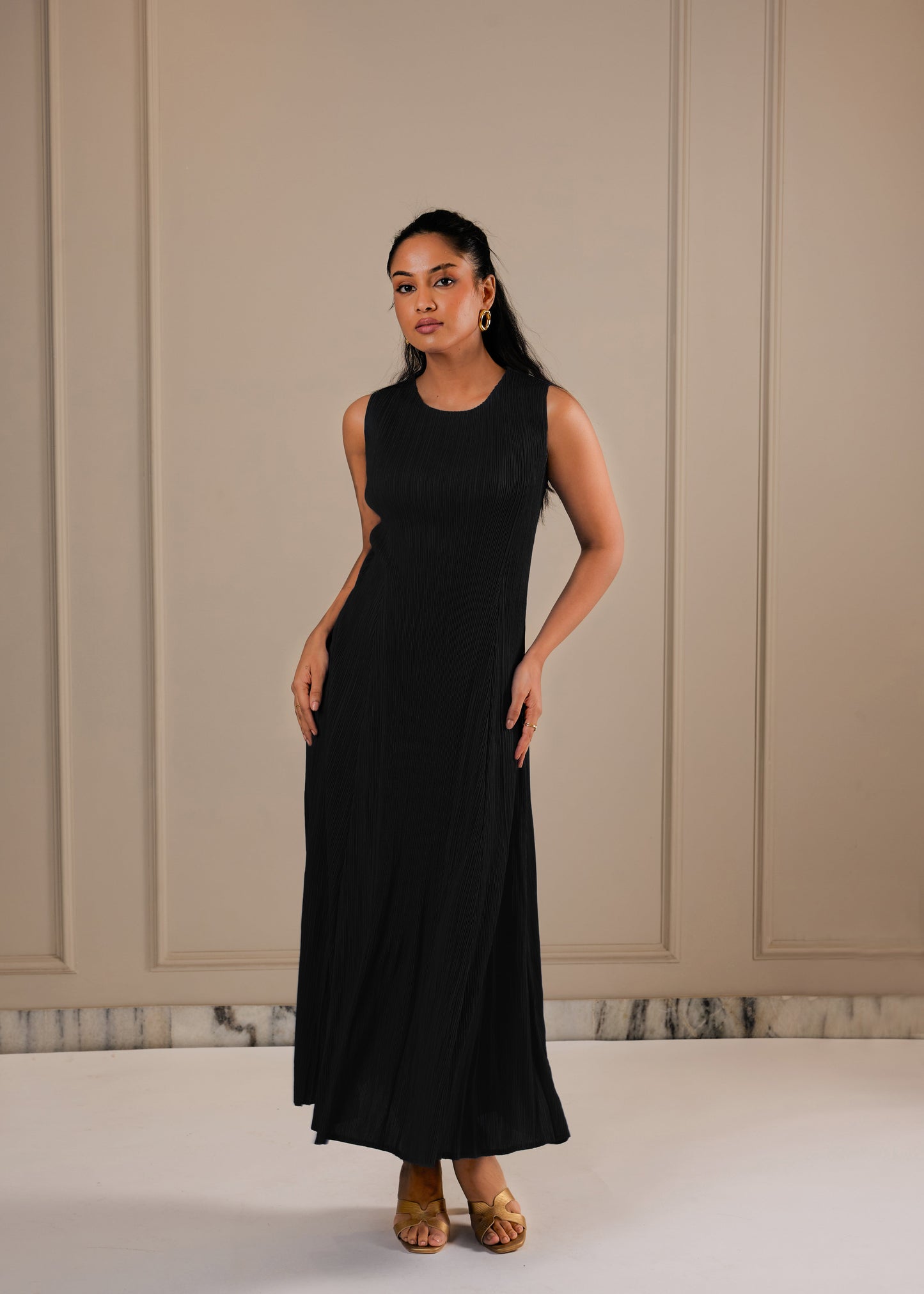 Woman wearing Black A line dress with Fringe cape and a belt