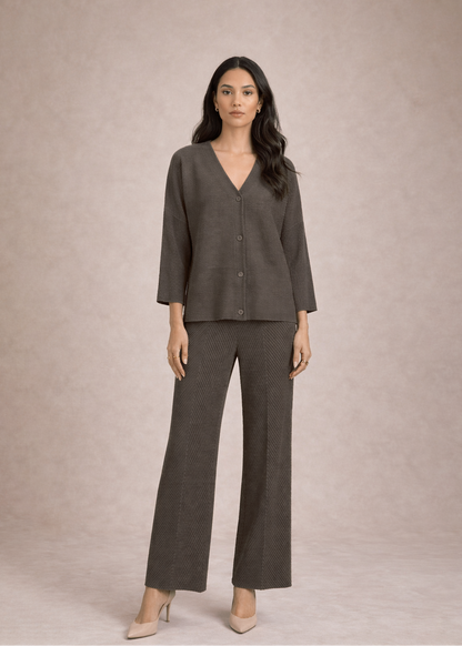 Woman wearing a gray suit against a beige background