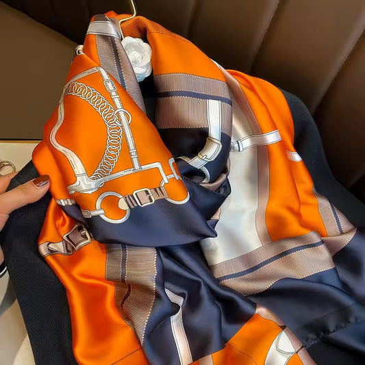 Colorful scarf with horsebit pattern draped over a surface