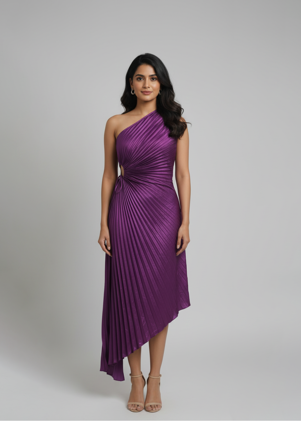 Woman wearing a purple one-shoulder dress against a gray background