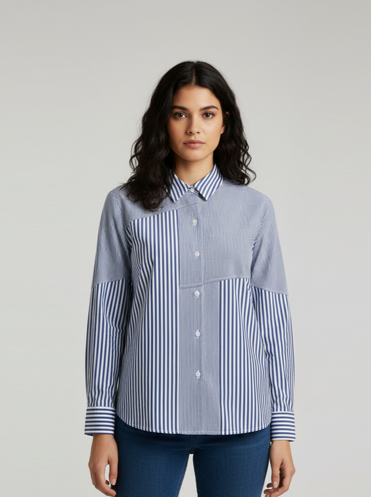 Woman wearing a blue and white striped shirt against a gray background