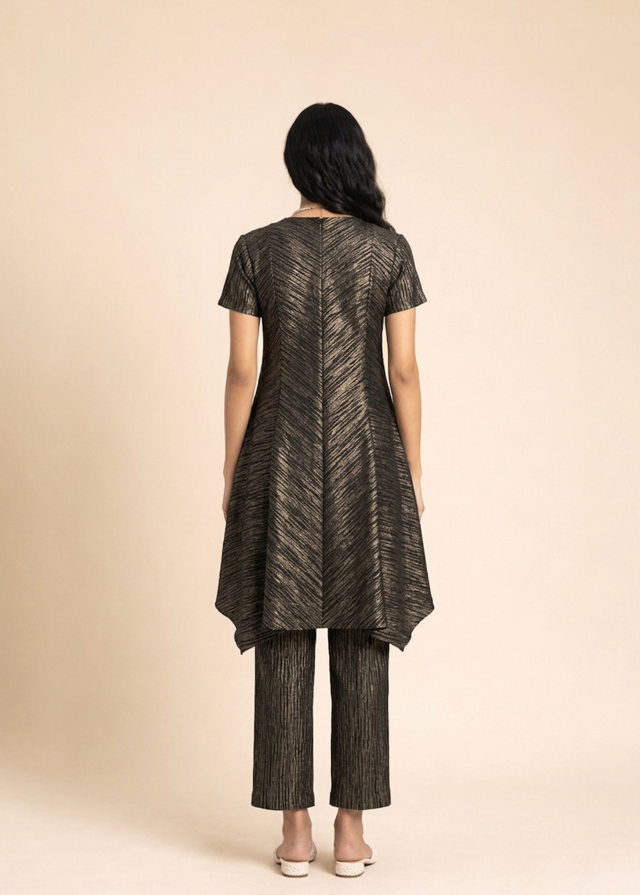 Woman wearing a black and gold patterned outfit on a beige background