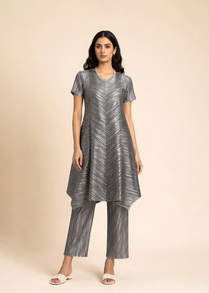 Woman wearing a silver patterned outfit on a beige background