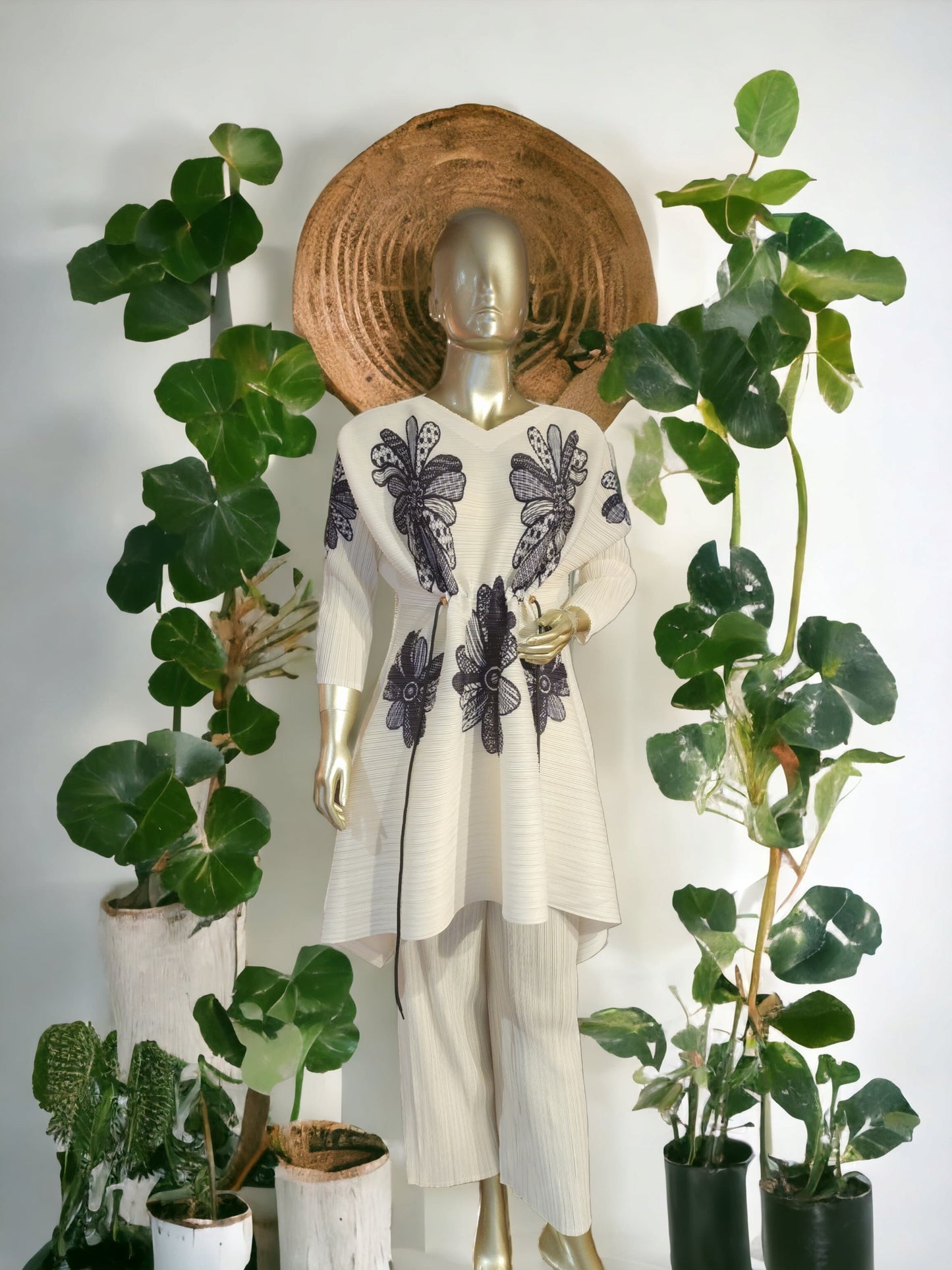 White long tunic with navy floral motifs with a string at waist to adjust the waistline paired straight ankle length pants.