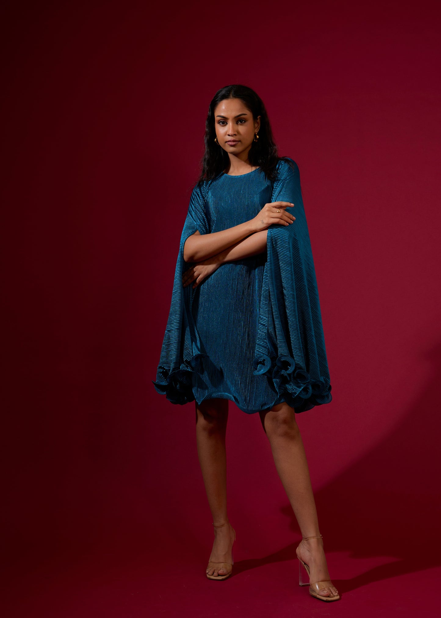 Woman wearing a blue dress against a red background